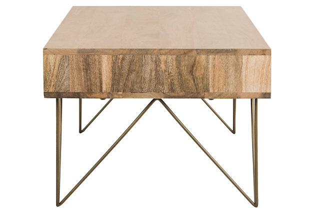 Striking and stylish, the mid-century influence of this rectangular coffee table is evident in the hairpin design legs. Crafted of mango wood with an asymmetric drawer design, its minimalist lines are highlighted with a natural finish that allows the beauty of the wood grain to steal the show.Made of mango wood | Natural finish | Brass-tone powdercoat metal legs | Clean with a soft, dry cloth | Assembly required