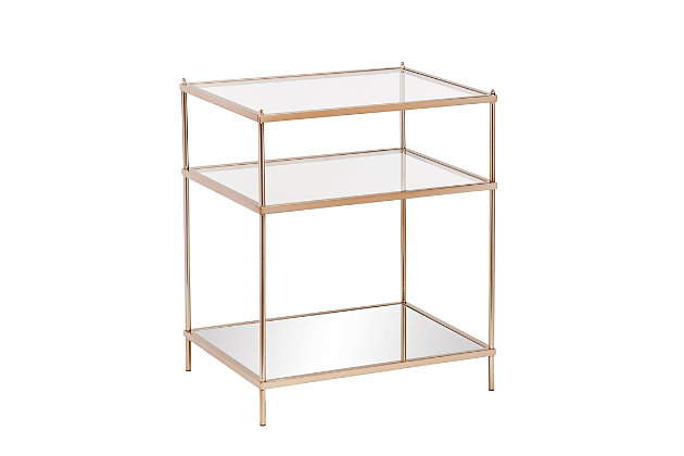 By infusing goldtone metal with both clear and mirrored glass, this decidedly modern end table takes minimalism to the max. Tri-level design gives its fabulous form that much more function.Plated iron frame in goldtone finish | Clear tempered glass tabletop and center shelf | Bottom shelf with mirrored glass top | Assembly required | Assembly time frame is 15 to 30 min.