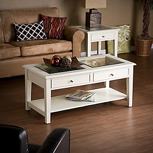 Finished in a delightful off-white, this clean-lined coffee table is an inspired choice for those who prefer that personal touch. The tabletop wows with transparent tempered glass insets, perfect for showing off everything from seashells and souvenirs to family photos. Dual drawers and an underlying shelf add to the form and functionality.Made of wood, veneer and engineered wood | Off-white finish | Tabletop with tempered glass insets | Brushed nickel-tone knobs | 2 drawers | Fixed shelf | Assembly required | Assembly time frame is 45 to 60 min.