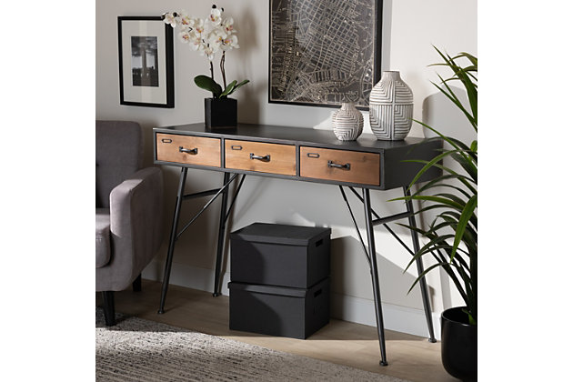 Add an artistic charm to your entryway with the Ariana console table. Made in China, this piece contains three drawers which give plenty of space for keys, mail, or supplies. A rigid frame and crisp angles give the Ariana a sleek design that helps it stand out in busy areas. This piece requires assembly and is supported by thin, angled legs that fit well in tight spaces and allow for additional storage space underneath. Oak Brown finished wood drawer fronts, adorned with black handles, give the Ariana an industrial appeal that adds personality to any entrance.Constructed from MDF wood and metal | Oak finished drawer fronts | Black finished frame | Three (3) drawers