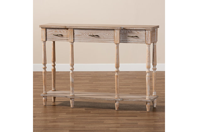 Revitalize your entryway with the elegant and efficient Hallan console table. Made in China, this wood console is finished in a whitewashed oak brown that lends rustic, old world appeal. Three drawers and a lower shelf provide space to store mail and display decor. Crisp lines lend contemporary style, while ring turned legs add a traditional look. The Hallan requires assembly and is accented with antique gold tone metal drawer pulls for a touch of vintage charm. With plenty of surface area for storage and decorations, the Hallan console table is a fantastic addition to any entryway.Constructed from firwood and engineered wood | Whitewashed oak brown finish | Three (3) drawers | Lower shelf