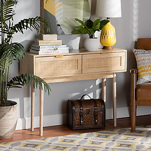 Add a retro inspired accent to your entryway with the stunning Baird console table. Made in China, the Baird is comprised of sturdy wood showcasing a light oak brown finish. Two drawers provide space to store keys and mail, while the wide tabletop offers room to display plants and decor. Requiring assembly, the console features woven rattan drawer faces and gold tone metal handles for eye catching style. A handy piece brimming with personality, the Baird console is sure to enhance any space.Constructed from pine wood, rattan, and engineered wood | Light oak brown finish | Two (2) drawers | Woven rattan drawer faces