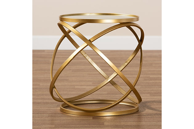 Accent your space with the glamorous design of the Desma end table. Made in China, the Desma is comprised of a sculptural brushed gold finished frame. The circular mirrored glass tabletop provides space for beverages and decor, while also complementing the intertwined forms on the base. Fully assembled, its compact size makes it easy to place in a variety of room layouts. Combining utility with luxury, the Desma end table elevates the character of any space.Glam and luxe end table | Constructed from metal and mirrored glass | Brushed gold finish | Round tabletop