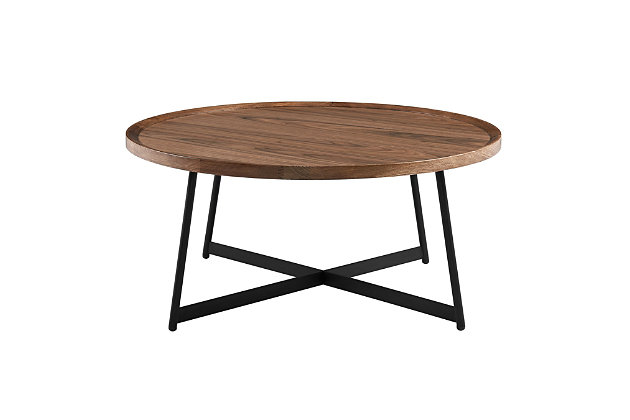 The Niklaus round coffee table is both perfectly symmetrical and distinguished. With a walnut top, solid edges and a black steel base, let this coffee table catch the eye of any wandering guest. Prominent and bold, while also graceful.Made with metal | American walnut veneered top | Black finished base | Sleek design | Assembly required