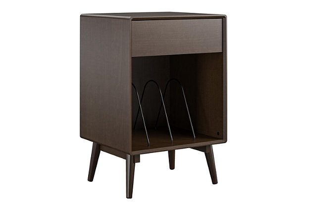 Give your living room or entertainment space a retro look with the Novogratz Brittany Turntable Stand. The beautiful walnut finish on wood veneer gives the look and feel of real wood and pairs with the angled real wood legs for a trendy mid-century modern look. The Stand is the perfect size to place your record player and the cubby with metal record dividers keeps your albums organized. The drawer is perfect to store away remotes, batteries, and extra cables. The Novogratz Brittany Turntable Stand ships flat to your door and requires assembly upon opening. Two adults are recommended to assemble. Once assembled, the Stand measures to be 30"H x 19.88"W x 17.72"D.Take it back in time with the novogratz brittany turntable stand | Made with wood veneer with real wood legs, the beautiful walnut finish pairs with the angled legs for a trendy look | The stand is the perfect size to place your record player and keep your albums organized in the lower cubby with metal record dividers. Store away remotes and cables in the convenient drawer | Complete your space with the entire brittany collection (each sold separately) | The stand ships flat to your door and 2 adults are recommended to assemble. The stand can support up to 50 lbs. While the lower cubby can hold 40 lbs. The drawer can hold up to 15 lbs. Assembled dimensions: 30"h x 19.88"w x 17.72"d | 1 year limited warranty is included