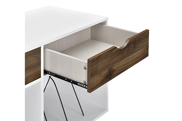 Add a blast from the past with the Novogratz Concord Turntable Stand with Drawers. Inspired from mid-century design, the laminated particleboard and MDF complement the black metal hairpin legs for a fun retro look. The white chassis and contrasting medium brown woodgrain drawer fronts pair well with any décor from modern to classic. The double wide stand offers plenty of space to place a record player, speakers, and stereo or even decorations. Keep your remotes, cassette tapes, and record mats or weights for your singles stored away and organized in the 2 drawers. The drawer cutout gives the stand a clean, no-handle look that is easy to open. Keep all of your albums organized in the large open cubbies that feature metal record dividers to keep all of your albums upright. The Novogratz Concord Turntable Stand with Drawers ships flat to your door and 2 adults are recommended for assembly upon opening. The Stand can hold up to 60 lbs. while the cubbies will hold 20 lbs. each. Each drawer can hold up to 15 lbs. Upon assembly, the Stand measures to be 31.8"H x 39.7"W x 18"D.Take it back in time with the novogratz concord turntable stand with drawers | The white laminated particleboard and mdf chassis offer a strong build that complements the mid-century inspired black metal hairpin legs. The contrasting medium brown woodgrain drawer fronts give the stand a classic look to add to any style | The double wide stand offers plenty of space for a record player, speakers and stereo and features 2 large open cubbies with metal dividers to keep your albums upright and organized. Keep your remotes, cassette tapes, and record mats or weights stored away in the 2 spacious drawers | Complete your collection with other novogratz items (sold separately) | The novogratz concord turntable stand with drawers ships flat to your door and 2 adults are recommended for assembly. The stand can hold up to 60 lbs. While the cubbies will hold 20 lbs. Each. Each drawer can hold up to 15 lbs. Assembled dimensions: 31.8"h x 39.7"w x 18"d | 1 year limited warranty included