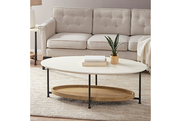 Modernize your living room decor with this coffee table. Flaunting an eye-catching design, the oval table's white top and black metal legs create a bold contemporary look. A lower shelf in a natural finish provides space to display and store your magazines and other essentials.Made with solid wood and engineered wood | Metal base with black finish | Tabletop with white finish | Open lower shelf with natural finish | Assembly required | Imported