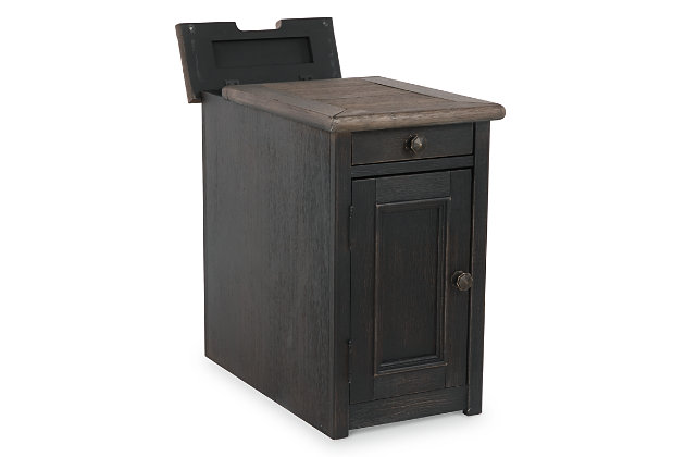 Shabby chic with a hint of down home country. The Tyler Creek chairside end table with textured black finish is all the talk of today’s design world. Wood grain shows through the weathered gray-brown top in all of its earthy pleasure. Pull-out tray with lovely traditional hardware has two cup holders. Fuel up your devices with the convenient charging station.Made of solid and engineered wood and veneers | Dark bronze-tone hardware | 1 door; 1 fixed shelf | Pull-out tray with 2 cup holders | AC power supply with 2 USB charging ports | Assembly required