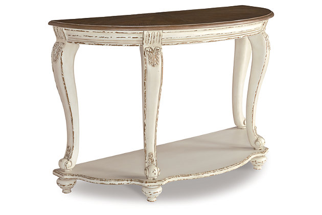 Elevating the art of traditional cottage styling, the Realyn demilune sofa table is sure to serve you beautifully for years to come. Antiqued two-tone aesthetic blends a chipped white with a distressed wood finished top for added charm. Classic cabriole legs and shapely lower shelf are a lovely twist. Decorative corbels add refinement.Made of veneers, wood and engineered wood, with cast resin components | Antiqued two-tone finish | Fixed lower shelf | Assembly required | Estimated Assembly Time: 15 Minutes