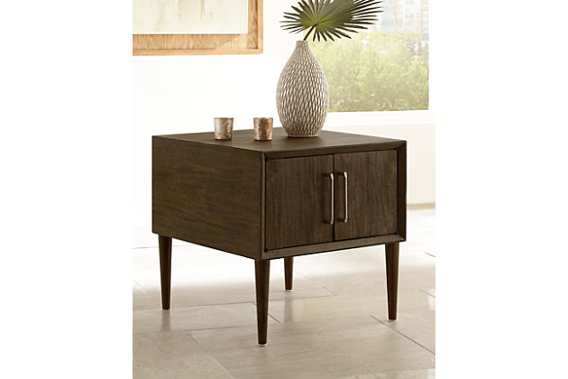 With its tapered peg legs and low, linear profile, the Kisper end table with cabinet storage space is a mastery in mid-century minimalism. The look may be high-end gallery design, but the price is beautifully down to earth.Made of veneers, wood and engineered wood | Cabinet storage space | Aged pewter tone hardware | Assembly required | Estimated Assembly Time: 15 Minutes