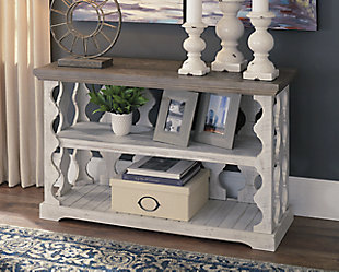 With its richly rustic finish and textural mix, the Havalance sofa table goes to town on bygone beauty. Its distressed two-tone treatment blends a weathered gray with vintage white for an utterly charming effect. Balustrade-style planks supporting the top create an eye-catching look that’s anything but ordinary.Made of pine wood, pine veneer and engineered wood | Two-tone distressed finish; weathered gray top and vintage white base | Fixed center shelf; lower display space | Assembly required | Estimated Assembly Time: 30 Minutes
