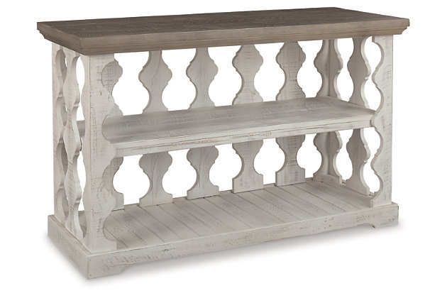 With its richly rustic finish and textural mix, the Havalance sofa table goes to town on bygone beauty. Its distressed two-tone treatment blends a weathered gray with vintage white for an utterly charming effect. Balustrade-style planks supporting the top create an eye-catching look that’s anything but ordinary.Made of pine wood, pine veneer and engineered wood | Two-tone distressed finish; weathered gray top and vintage white base | Fixed center shelf; lower display space | Assembly required | Estimated Assembly Time: 30 Minutes