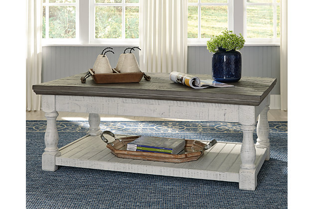 With its richly rustic finish and textural mix, the Havalance lift-top coffee table goes to town on bygone beauty. Its distressed two-tone treatment blends a weathered gray with vintage white for an utterly charming effect. The lift-top design adds function to your very comfortable space.Made of pine wood, veneers and engineered wood | Two-tone distressed finish; weathered gray top and vintage white base | Spring-lift top | 2 hidden storage trays | Fixed lower shelf | Assembly required | Estimated Assembly Time: 30 Minutes