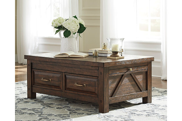 Windville coffee table with storage serves up richly rustic style with added dimension. Dual side pull-out trays expand your surface space, while a pair of smooth-gliding drawers help keep things clutter free. Distinctive elements include mango veneers for dramatic grainy character, along with angled braced sides and antiqued brass-tone pulls for vintage charm.Made of mango veneers, wood and manmade wood | 2 smooth-gliding drawers with dovetail construction and metal ball bearing slides | Antiqued brass-tone hardware | 2 pull-out trays