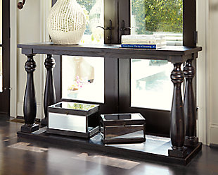 The Mallacar black sofa table has a dramatic presence—exactly what an eclectically styled room needs. Solid wood planks and thick veneer merge seamlessly together for a hearty helping of style. Handsomely turned legs connect to a lower shelf flush with the floor. A rustic wirebrush technique gives this stunning sofa end table in black with show-through contrasting just enough of a weathered sensibility.Sofa table made of veneers, wood and engineered wood | Rich black finish with show-through effect | Lower shelf provides essential display and storage space | Made of veneers, wood and engineered wood | Saw cut planking | Rustic wirebrush details give the table a weathered aesthetic | Assembly required | Estimated Assembly Time: 15 Minutes