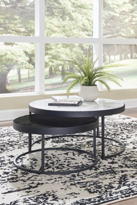 This space-saving design mixes metal, glass and natural marble into modern coffee tables with a contemporary edge. Designed to make the most of your space, the Windron nesting table set features one white natural marble tabletop and one inset black glass tabletop, both supported by open metal frames with black powder coated finish. With ample display surfaces, these tables make a naturally cool addition to any space.Set of 2 | Made of natural marble, metal and glass | Large tabletop with white marble | Small tabletop with inset black glass | Metal frame with black powder coated finish | Nesting design | Assembly required | Estimated Assembly Time: 30 Minutes
