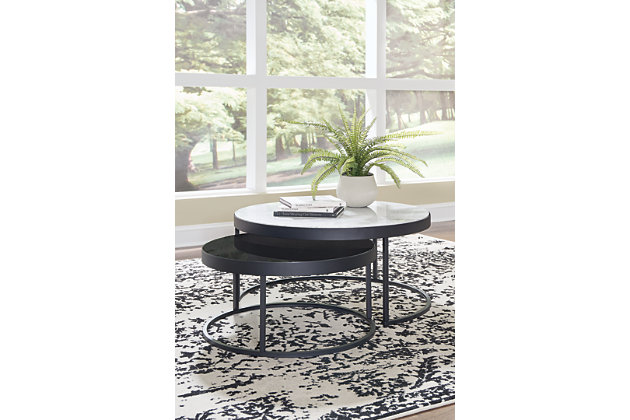 This space-saving design mixes metal, glass and natural marble into modern coffee tables with a contemporary edge. Designed to make the most of your space, the Windron nesting table set features one white natural marble tabletop and one inset black glass tabletop, both supported by open metal frames with black powder coated finish. With ample display surfaces, these tables make a naturally cool addition to any space.Set of 2 | Made of natural marble, metal and glass | Large tabletop with white marble | Small tabletop with inset black glass | Metal frame with black powder coated finish | Nesting design | Assembly required | Estimated Assembly Time: 30 Minutes