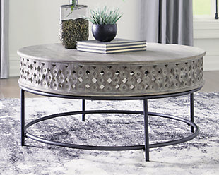 The Rastella round coffee table is reserved for those carving out a cool, eclectic aesthetic. Elements of this distinctive table crafted with India mango wood include hand-carved aprons forming an open lattice weave. Metal frame in matte black is a striking complement to the tabletop’s burnished gray finish.Hand-carved India mango wood tabletop in burnished gray finish | Matte back metal base | Assembly required | Estimated Assembly Time: 15 Minutes