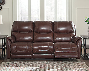 What could be better than the indulgent feel of genuine leather? How about fashion-forward looks to match. And a one-touch power control that delivers unsurpassed comfort and support. Rest assured, the Mancelona power reclining sofa with 43" high back is designed to pamper from head to toe. Sporting a real leather seating area for buttery-soft pleasure, this contemporary reclining sofa with distinctive jumbo stitching takes it up a notch with one-touch power lumbar support and an Easy View™ power adjustable headrest that lets you fully recline and still have a primo view of the TV. Let’s not forget the USB plug-in that lets you recharge while you unwind.Dual-sided recliner; middle seat remains stationary | One-touch power control with adjustable positions, Easy View™ adjustable headrest, power lumbar support and USB plug-in | Corner-blocked frame with metal reinforced seat | Attached cushions | High-resiliency foam cushions wrapped in thick poly fiber | Leather interior upholstery; vinyl/polyester exterior upholstery | Power cord included; UL Listed