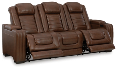 With its fashion-forward sense of style, the Backtrack power reclining sofa has you covered with high-tech advancements and down-home comfort. For starters, the seating area and armrests are upholstered in real leather for true indulgence where it matters most. Love being pampered? With the touch of a button, experience the pure bliss of an air massage system (with three settings), or chill out with the heated seat element. Distinctive elements of this power recliner include contemporary waterfall tufting that beautifully goes with the flow and a zero-gravity mechanism further raising the ottoman for better blood flow. Dual-sided recliner | One-touch power control with adjustable positions, Easy View™ adjustable headrest and zero-draw USB plug-in | Zero-draw technology only consumes power when the USB receptacle is in use | Air massage system includes 3 settings: steady, pulse and wave (with automatic 20-minute shutoff feature) | Heat in the seat element (with automatic 30-minute shutoff feature) | Corner-blocked frame with metal reinforced seat | Attached back and seat cushions | High-resiliency foam cushions wrapped in thick poly fiber | Hidden armrest storage compartments | Zero-gravity mechanism (raises the ottoman to 23" off the floor for improved blood flow) | Extended ottoman for enhanced comfort | Leather interior seating; vinyl/polyester exterior upholstery | Middle seat with flip-down table and 2 cup holders | Estimated Assembly Time: 15 Minutes