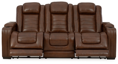 With its fashion-forward sense of style, the Backtrack power reclining sofa has you covered with high-tech advancements and down-home comfort. For starters, the seating area and armrests are upholstered in real leather for true indulgence where it matters most. Love being pampered? With the touch of a button, experience the pure bliss of an air massage system (with three settings), or chill out with the heated seat element. Distinctive elements of this power recliner include contemporary waterfall tufting that beautifully goes with the flow and a zero-gravity mechanism further raising the ottoman for better blood flow. Dual-sided recliner | One-touch power control with adjustable positions, Easy View™ adjustable headrest and zero-draw USB plug-in | Zero-draw technology only consumes power when the USB receptacle is in use | Air massage system includes 3 settings: steady, pulse and wave (with automatic 20-minute shutoff feature) | Heat in the seat element (with automatic 30-minute shutoff feature) | Corner-blocked frame with metal reinforced seat | Attached back and seat cushions | High-resiliency foam cushions wrapped in thick poly fiber | Hidden armrest storage compartments | Zero-gravity mechanism (raises the ottoman to 23" off the floor for improved blood flow) | Extended ottoman for enhanced comfort | Leather interior seating; vinyl/polyester exterior upholstery | Middle seat with flip-down table and 2 cup holders | Estimated Assembly Time: 15 Minutes