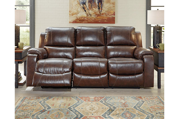 Once you recline in the Rackingburg dual reclining power sofa at the push of a button, you will not want to get up. It's that comfortable with bustle backs and padded ottomans. Its look is amazing with dramatic cut and sew lines, jumbo stitching and affordable mahogany leather match upholstery, which features top-grain leather in the seating areas with skillfully matched vinyl everywhere else—what a way to relax.Dual-sided recliner; middle seat remains stationary | One-touch power controls with adjustable positions | Bustle backs | Attached cushions | Corner-blocked frame with metal reinforced seat | Leather interior upholstery/polyester and vinyl exterior upholstery | High-resiliency foam cushions wrapped in thick poly fiber | Power cord included; UL Listed