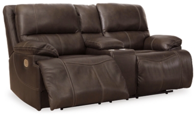 Life is so much better when you can enjoy the pleasure of real leather—at a price to put you at ease. That’s exactly what you get with the Ricmen sectional with power. Thanks to real leather throughout the seating area, you've got a reclining sectional that feels like a million bucks but won’t break the bank. Tailored to those with an eye for contemporary design, this power reclining sectional is dressed to impress with an upscale matte finish, clean-lined divided back tufting, distinctive jumbo stitching and chic pillow top armrests. Perhaps best of all: Easy View™ power adjustable headrests let you recline back and still have a primo view of the TV.Includes 3 pieces: power reclining loveseat, 2 seat power reclining sofa and wedge | Dual-sided recliner | One-touch power control with adjustable positions | Corner-blocked frame with metal reinforced seat | Attached cushions | High-resiliency foam cushions wrapped in thick poly fiber | USB charging port in power control | Easy View™ power adjustable headrests | Loveseat console with storage and 2 cup holders | Leather interior upholstery; vinyl/polyester exterior upholstery | Power cord included; UL Listed | Estimated Assembly Time: 10 Minutes