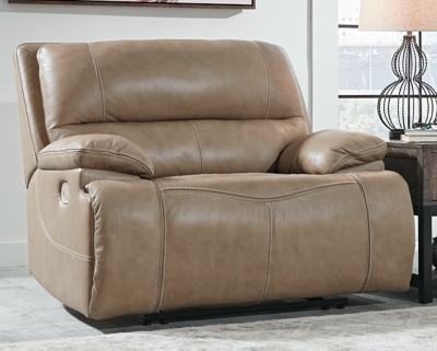 Life is so much better when you can enjoy the pleasure of real leather—at a price to put you at ease. That’s exactly what you get with the Ricmen wide seat power recliner. Thanks to real leather throughout the seating area, you've got a recliner that feels like a million bucks but won’t break the bank. Tailored to suit those with an eye for contemporary design, this power recliner is dressed to impress with an upscale matte finish, clean-lined divided back tufting, distinctive jumbo stitching and chic pillow top armrests. Perhaps best of all: an Easy View™ power adjustable headrest lets you recline back and still have a primo view of the TV.One-touch power control with adjustable positions | Corner-blocked frame with metal reinforced seat | Attached cushions | High-resiliency foam cushions wrapped in thick poly fiber | USB charging port in power control | Easy View™ power adjustable headrest | Extended ottoman for enhanced comfort | Leather interior upholstery; vinyl/polyester exterior upholstery | Power cord included; UL Listed