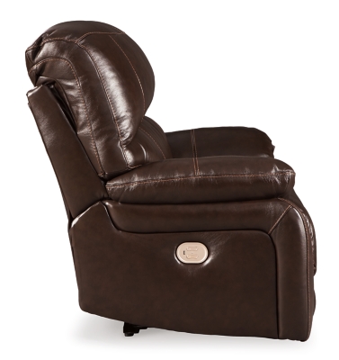 Fashion-forward style. Sumptuous leather feel and appeal. Total comfort at your fingertips. It’s all yours for the taking with the Hallstrung power recliner with adjustable headrest. Wrapped in a lavish chocolate-colored upholstery, this decidedly contemporary power recliner tantalizes the senses in so many ways. Rest assured, the wide seating area is covered in 100% leather for your pleasure, while a skillfully matched faux leather on the exterior makes luxury affordable. Upping the comfort with 44" high back styling, this power recliner truly caters from head to toe. An Easy View™ power adjustable headrest allows you to lean back while propping up your head—perfect for chilling out in front of the TV—while an extended ottoman lets you stretch out all the more. And with a USB port in the power control panel, you hardly have to move a muscle to stay powered up.High-resiliency foam cushions wrapped in thick poly fiber | Corner-blocked frame with metal reinforced seat | One-touch power control with adjustable positions | 44" high back design | Attached back and seat cushions | Easy View™ power adjustable headrest | Extended ottoman for enhanced comfort | Leather interior upholstery; polyester/vinyl exterior upholstery | Includes USB charging port in each power control | Power cord included; UL Listed | Estimated Assembly Time: 15 Minutes