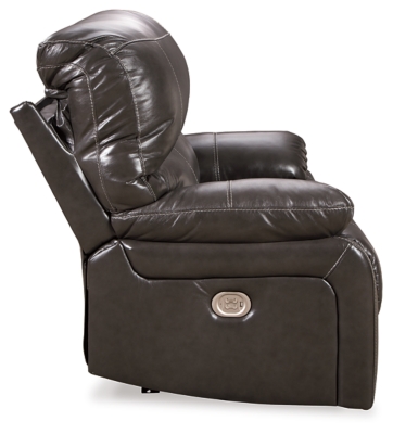 Fashion-forward style. Sumptuous leather feel and appeal. Total comfort at your fingertips. It’s all yours for the taking with the Hallstrung power recliner with adjustable headrest. Wrapped in an attractive gray upholstery, this decidedly contemporary power recliner tantalizes the senses in so many ways. Rest assured, the wide seating area is covered in 100% leather for your pleasure, while a skillfully matched faux leather on the exterior makes luxury affordable. Upping the comfort with 44" high back styling, this power recliner truly caters from head to toe. An Easy View™ power adjustable headrest allows you to lean back while propping up your head—perfect for chilling out in front of the TV—while an extended ottoman lets you stretch out all the more. And with a USB port in the power control panel, you hardly have to move a muscle to stay powered up.High-resiliency foam cushions wrapped in thick poly fiber | Corner-blocked frame with metal reinforced seat | One-touch power control with adjustable positions | 44" high back design | Attached back and seat cushions | Easy View™ power adjustable headrest | Leather interior upholstery; polyester/vinyl exterior upholstery | Extended ottoman for enhanced comfort | Includes USB charging port in the power control | Power cord included; UL Listed | Estimated Assembly Time: 15 Minutes