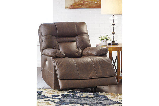 Big and bold, the Wurstrow power recliner with Easy View™ power adjustable headrest delivers comfort at the touch of a button. Easily position the recliner, its headrest and lumbar support to your liking for maximum comfort. Plus, with the convenient USB charging port, a cell phone or laptop can be charged without having to get up. The feel of heavy weight leather surrounds you via the cushioned seat, interior bustled back cushioning and pillow top armrests, while faux leather is on the back and sides for affordability. The cloud effect seen in the umber-colored upholstery creates a rustic look—perfect for your modern or casual setting.One-touch power control recliner with adjustable positions | Corner-blocked frame with metal reinforced seat | Attached back and seat cushions | High-resiliency foam cushions wrapped in thick poly fiber | Easy View™ power adjustable headrest and adjustable lumbar support | Extended ottoman for enhanced comfort | 100% genuine top-grain leather throughout the seating area and armrests | High quality leather substitute covers remaining areas | Includes USB charging port in the power control | Power cord included; UL Listed