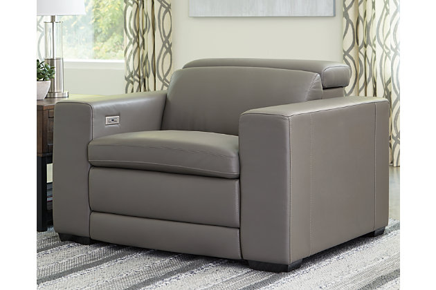 Truly putting high design into recline, the Texline recliner in gray with genuine leather seating area proves that just because you’re a recliner doesn’t mean you have to look like one. Deceptively beautiful, its ultra clean-lined aesthetic is as cool and contemporary as they come. The low-profile back has a super swank look. When you need more support for your head and neck, the press of a button engages the Easy View™ power adjustable headrest, designed to let you lean back and still have a primo view of the TV. To save space, the zero wall design requires minimal space between wall and chair back. Indulgent pillow top seating gives an added layer of comfort.One-touch power control with adjustable positions, Easy View™ adjustable headrest and zero-draw USB plug-in | Zero-draw technology only consumes power when the USB receptacle is in use | Corner-blocked frame with metal reinforced seat | Attached cushions | Pillow top seats | High-resiliency foam cushions wrapped in thick poly fiber | Zero wall design requires minimal space between wall and chair back | Extended ottoman for enhanced comfort | Leather interior upholstery; vinyl/polyester exterior upholstery | Power cord included; UL Listed | Exposed tapered feet