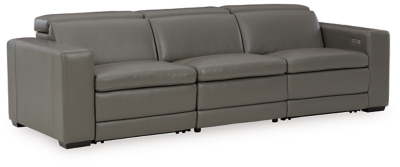 Truly putting high design into recline, the Texline sofa with genuine leather seating area proves that just because you’re a recliner doesn’t mean you have to look like one. Deceptively beautiful, its ultra clean-lined aesthetic is as cool and contemporary as they come. Low-profile back has a super swank look. When you need more support for your head and neck, the press of a button engages the Easy View™ power adjustable headrest, designed to let you lean back and still have a primo view of the TV. The zero wall design requires minimal space between wall and chair back, and indulgent pillow top seating gives an added layer of comfort.Includes 4 pieces: right-arm facing armless power recliner, left-arm facing armless power recliner and armless chair and left-arm/right-arm facing power arm | One-touch power control with adjustable positions, Easy View™ adjustable headrest and zero-draw USB plug-in | Zero-draw technology only consumes power when the USB receptacle is in use | Corner-blocked frame with metal reinforced seat | Attached back and seat cushions | Pillow top seats | High-resiliency foam cushions wrapped in thick poly fiber | Zero wall design requires minimal space between wall and chair back | Extended ottoman for enhanced comfort | Leather interior upholstery; vinyl/polyester exterior upholstery | Power cord included; UL Listed | Exposed feet with faux wood finish | Estimated Assembly Time: 60 Minutes