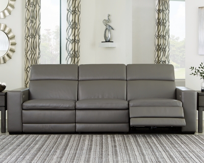 Truly putting high design into recline, the Texline sofa with genuine leather seating area proves that just because you’re a recliner doesn’t mean you have to look like one. Deceptively beautiful, its ultra clean-lined aesthetic is as cool and contemporary as they come. Low-profile back has a super swank look. When you need more support for your head and neck, the press of a button engages the Easy View™ power adjustable headrest, designed to let you lean back and still have a primo view of the TV. The zero wall design requires minimal space between wall and chair back, and indulgent pillow top seating gives an added layer of comfort.Includes 4 pieces: right-arm facing armless power recliner, left-arm facing armless power recliner and armless chair and left-arm/right-arm facing power arm | One-touch power control with adjustable positions, Easy View™ adjustable headrest and zero-draw USB plug-in | Zero-draw technology only consumes power when the USB receptacle is in use | Corner-blocked frame with metal reinforced seat | Attached back and seat cushions | Pillow top seats | High-resiliency foam cushions wrapped in thick poly fiber | Zero wall design requires minimal space between wall and chair back | Extended ottoman for enhanced comfort | Leather interior upholstery; vinyl/polyester exterior upholstery | Power cord included; UL Listed | Exposed feet with faux wood finish | Estimated Assembly Time: 60 Minutes