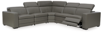 Truly putting high design into recline, the Texline sectional with genuine leather seating area proves that just because you’re a recliner doesn’t mean you have to look like one. Deceptively beautiful, its ultra clean-lined aesthetic is as cool and contemporary as they come. Low-profile back has a super swank look. When you need more support for your head and neck, the press of a button engages the Easy View™ power adjustable headrest, designed to let you lean back and still have a primo view of the TV. The zero wall design requires minimal space between wall and chair back, and indulgent pillow top seating gives an added layer of comfort.Includes 6 pieces: right-arm facing armless power recliner, left-arm facing armless power recliner, left-arm/right-arm facing power arm, 2 armless chairs and wedge | One-touch power control with adjustable positions, Easy View™ adjustable headrest and zero-draw USB plug-in | Zero-draw technology only consumes power when the USB receptacle is in use | Corner-blocked frame with metal reinforced seat | Attached back and seat cushions | Pillow top seats | High-resiliency foam cushions wrapped in thick poly fiber | Zero wall design requires minimal space between wall and chair back | Extended ottoman for enhanced comfort | Leather interior upholstery; vinyl/polyester exterior upholstery | Power cord included; UL Listed | Exposed feet with faux wood finish | Estimated Assembly Time: 80 Minutes