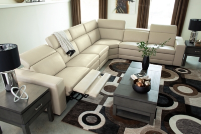 Truly putting high design into recline, the Texline sectional with genuine leather seating area proves that just because you’re a recliner doesn’t mean you have to look like one. Deceptively beautiful, its ultra clean-lined aesthetic is as cool and contemporary as they come. Low-profile back has a super swank look. When you need more support for your head and neck, the press of a button engages the Easy View™ power adjustable headrest, designed to let you lean back and still have a primo view of the TV.Includes 6 pieces: right-arm facing armless power recliner, left-arm facing armless power recliner, left-arm/right-arm facing power arm, 2 armless chairs and wedge | One-touch power control with adjustable positions, Easy View™ adjustable headrest and zero-draw USB plug-in | Zero-draw technology only consumes power when the USB receptacle is in use | Corner-blocked frame with metal reinforced seat | Attached back and seat cushions | Pillow top seats | High-resiliency foam cushions wrapped in thick poly fiber | Extended ottoman for enhanced comfort | Leather interior upholstery; vinyl/polyester exterior upholstery    | Power cord included; UL Listed | Exposed feet with faux wood finish | Zero wall design requires minimal space between wall and chair back | Estimated Assembly Time: 110 Minutes