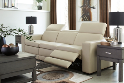 Truly putting high design into recline, the Texline sofa with genuine leather seating area proves that just because you’re a recliner doesn’t mean you have to look like one. Deceptively beautiful, its ultra clean-lined aesthetic is as cool and contemporary as they come. Low-profile back has a super swank look. When you need more support for your head and neck, the press of a button engages the Easy View™ power adjustable headrest, designed to let you lean back and still have a primo view of the TV. The zero wall design requires minimal space between wall and chair back, and indulgent pillow top seating gives an added layer of comfort.Includes 4 pieces: right-arm facing armless power recliner, left-arm facing armless power recliner, left-arm/right-arm facing power arm and armless chair | One-touch power control with adjustable positions, Easy View™ adjustable headrest and zero-draw USB plug-in | Zero-draw technology only consumes power when the USB receptacle is in use | Corner-blocked frame with metal reinforced seat | Attached back and seat cushions | Pillow top seats | High-resiliency foam cushions wrapped in thick poly fiber | Zero wall design requires minimal space between wall and chair back | Extended ottoman for enhanced comfort | Leather interior upholstery; vinyl/polyester exterior upholstery | Power cord included; UL Listed | Exposed feet with faux wood finish | Estimated Assembly Time: 75 Minutes