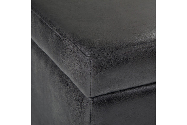 Great things come in small packages. When you are looking for a tasteful, well-made storage solution and extra seating, look no further than this storage ottoman bench. Made from durable faux leather, it’s extra strong and sturdy with a beautiful stitched exterior and a large storage interior. Whether you use the ottoman in your entryway, living room, family room or bedroom, it’s a pretty and practical extra seating option.Made of wood | Faux leather upholstery with stitching details | Top easily lifts to reveal hidden storage compartment | Child safety hinged top | Easy assembly required, simply attach feet