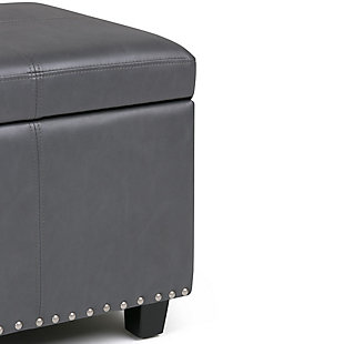 Why sacrifice function for beauty. When you are loo for a tasteful, well-made storage solution and extra seating, look no further than this storage ottoman. Made from durable faux leather, it’s extra strong and sturdy with a stitched exterior and a storage interior. Whether you are using it as an eating surface, a storage unit or just to put your feet up, this ottoman is a pretty and practical piece of furniture.Made of wood and engineered wood | Faux leather upholstery | Nailhead trim | Child safety hinge to prevent slamming | Easy assembly required, simply attach feet