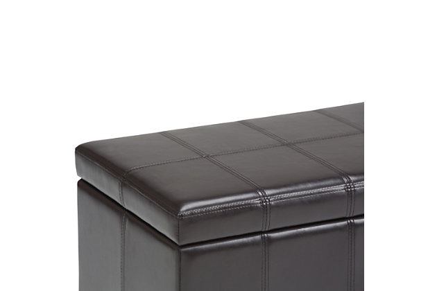 Why sacrifice function for beauty. When you are looking for a tasteful, well-made storage solution and extra seating, look no further than this storage ottoman. Made from durable faux leather, it’s extra strong and sturdy with a stitched exterior and a large storage interior. Whether you are using it as an eating surface, a storage unit or just to put your feet up, this ottoman is a pretty and practical piece of furniture.DIMENSIONS: 33.5” W x 18” D x 16.5”H | Hand constructed using solid wood, engineered wood and high density foam | Upholstered with a durable Tanners Brown PU Faux Leather | Features large interior storage space with child safety hinge to prevent lid slamming | Multi-functional ottoman can be used in bedroom, living room, family room, hallway as an entryway bench, foot stool, accent furniture or provide additional sitting | Transitional design includes stitched detail and nailhead trim at the bottom | Simple assembly; just attach legs | We believe in creating excellent, high quality products made from the finest materials at an affordable price. Every one of our products come with a 1-year warranty and easy returns if you are not satisfied.