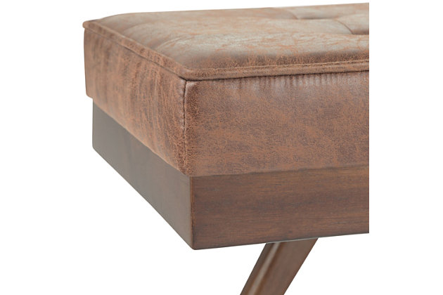 Why sacrifice function for beauty. When you are looking for extra seating, look no further than this ottoman bench. Covered in faux leather upholstery, it’s extra strong and sturdy with a button-tufted seat and canted legs. Whether you are using it in your entryway, living room or bedroom, this bench is a pretty and practical piece of furniture.DIMENSIONS: 47.75"W x 18.5"D x 18.4"H | Hand constructed using solid rubberwood, plywood, high density foam | Upholstered with a durable Distressed Umber Brown Faux Leather | Features comfortable thick cushioned top with button tufting detail, solid wood framed ottoman base and legs | Multi-functional ottoman can be used in bedroom, living room, family room, hallway as an entryway bench or provide additional sitting | Mid Century Design | Assembly required | We believe in creating excellent, high quality products made from the finest materials at an affordable price. Every one of our products come with a 1-year warranty and easy returns if you are not satisfied.