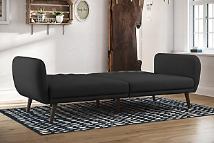 Be embraced by the comfortable cushioning of the Novogratz Brittany linen futon. With its ribbed tufted cushioned back, the Novogratz Brittany Linen futon gives your body all the support you need to sit and relax for hours. The combination of curved armrests and slanted legs work together to provide a unique rounded look that stands out. The linen upholstery adds another element of elegance ma this a perfect statement piece for any living space.Stylish linen upholstery wipes clean easily | Ribbed tufted cushioned back with slanted oak coloured wooden legs | Sturdy wood frame construction that is stable and durable | Comfortable polyester and foam filling