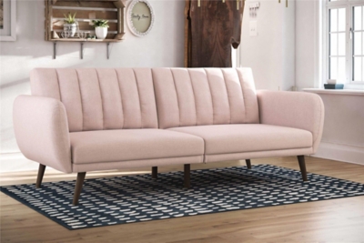 Be embraced by the comfortable cushioning of the Novogratz Brittany linen futon. With its ribbed tufted cushioned back, the Novogratz Brittany Linen futon gives your body all the support you need to sit and relax for hours. The combination of curved armrests and slanted legs work together to provide a unique rounded look that stands out. The linen upholstery adds another element of elegance making this a perfect statement piece for any living space.Stylish linen upholstery wipes clean easily | Ribbed tufted cushioned back with slanted oak coloured wooden legs | Sturdy wood frame construction that is stable and durable | Comfortable polyester and foam filling