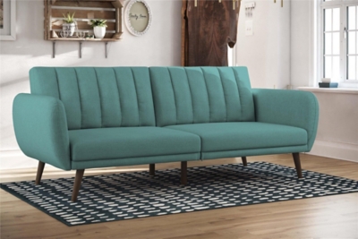 Be embraced by the comfortable cushioning of the Novogratz Brittany linen futon. With its ribbed tufted cushioned back, the Novogratz Brittany Linen futon gives your body all the support you need to sit and relax for hours. The combination of curved armrests and slanted legs work together to provide a unique rounded look that stands out. The linen upholstery adds another element of elegance making this a perfect statement piece for any living space.Stylish linen upholstery wipes clean easily | Ribbed tufted cushioned back with slanted oak coloured wooden legs | Sturdy wood frame construction that is stable and durable | Comfortable polyester and foam filling