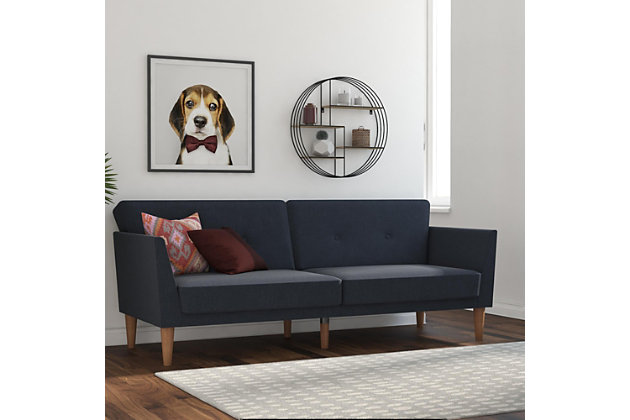 The 1950s are back in a big way, and living rooms across the country are being given a modern twist on the mid-century look that made straight lines and low profiles so popular. The Novogratz futon captures all that and more, with grey linen upholstery, a tufted back, wide winged arms, sleek style, and a wood frame that offers full support. The wood legs round off the look, with extra center legs that provide extra stability. You can also personalize your comfort level thanks to the split back, which allows you and a guest to each sit up or lounge back. Or simply open the Novogratz up into a sleeper sofa for overnight guests to spend the night. We’ve also added padding under the feet to protect your floors. Just add the Novogratz ottoman to really complete the look!Linen upholstery with tufted back and winged arms | Sturdy wood frame with stylish wood legs and padding under the feet to protect your floors from scuffs and scratches | Multi-functional piece ideal for small living spaces. Split back design provides multiple positions of comfort | Converts quickly and easily into a lounger and sleeper