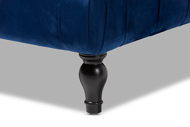 This ottoman complements your sense of style in a cool, contemporary way. A versatile accent piece, the ottoman doubles as a footrest or impromptu coffee table as the need arises. Upholstered in rich velvet with button tufted accents, the elegantly turned legs add classic appeal.Eucalyptus wood frame | Royal blue polyester velvet upholstery | Button tufted | Turned legs with non-marking feet | No assembly required