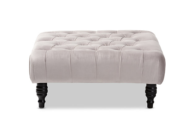 This ottoman complements your sense of style in a cool, contemporary way. A versatile accent piece, the ottoman doubles as a footrest or impromptu coffee table as the need arises. Upholstered in rich velvet with button tufted accents, the elegantly turned legs add classic appeal.Eucalyptus wood frame | Gray polyester velvet upholstery | Button tufted | Black finished legs with non-marking feet | No assembly required