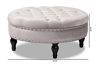 This round ottoman complements your sense of style in a cool, contemporary way. A versatile accent piece, the ottoman doubles as a footrest or impromptu coffee table as the need arises. Upholstered in rich velvet with button tufting and nailhead accents, the elegantly turned legs add classic appeal.Eucalyptus wood frame | Gray polyester velvet upholstery | Button tufted with nailhead trim | Black finished legs with non-marking feet | Leg assembly required