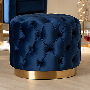 This modern and glamourous ottoman has luxury written all over it. From the plush cushion padded with foam and upholstered in a rich, soft to the touch velvet fabric, to the brushed goldtone finish on the base. The all-over button tufting highlights the subtle sheen of the velvet creating a decadently cool and comfortable appeal as a footstool or extra seating in your home.Engineered wood and stainless-steel frame | Royal blue polyester velvet upholstery | Button tufted | Brushed goldtone metal base | No assembly required