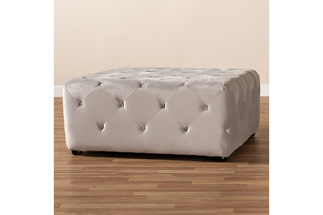 Raise your standard of living with this ottoman upholstered in a soft, sumptuous velvet fabric. Reserved exclusively for those with a penchant for high-glam home decor, this ultra-chic ottoman is dressed to impress with all over button tufting that simply works. Easy-on-the-eyes and alluring to the touch, this decidedly elegant and versatile ottoman can be used as a coffee table, footstool or as extra seating for guests.Eucalyptus wood frame | Slate gray polyester velvet upholstery with button tufting | Black finished feet | No assembly required